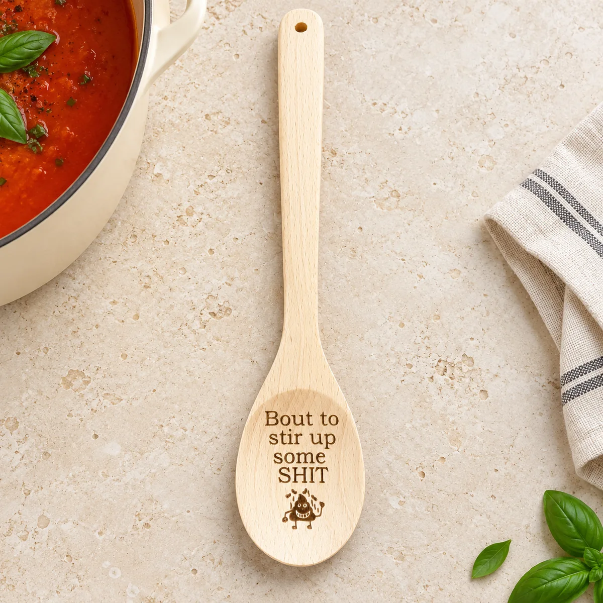 Bout to Stir Up Some Shit Engraved Wooden Spoon, on a limestone kitchen tabletop