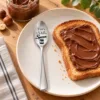Personalised Nutella Spoon beside toast with chocolate hazelnut spread.