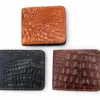 Three crocodile-pattern wallets in black, tan and dark brown arranged on a white background