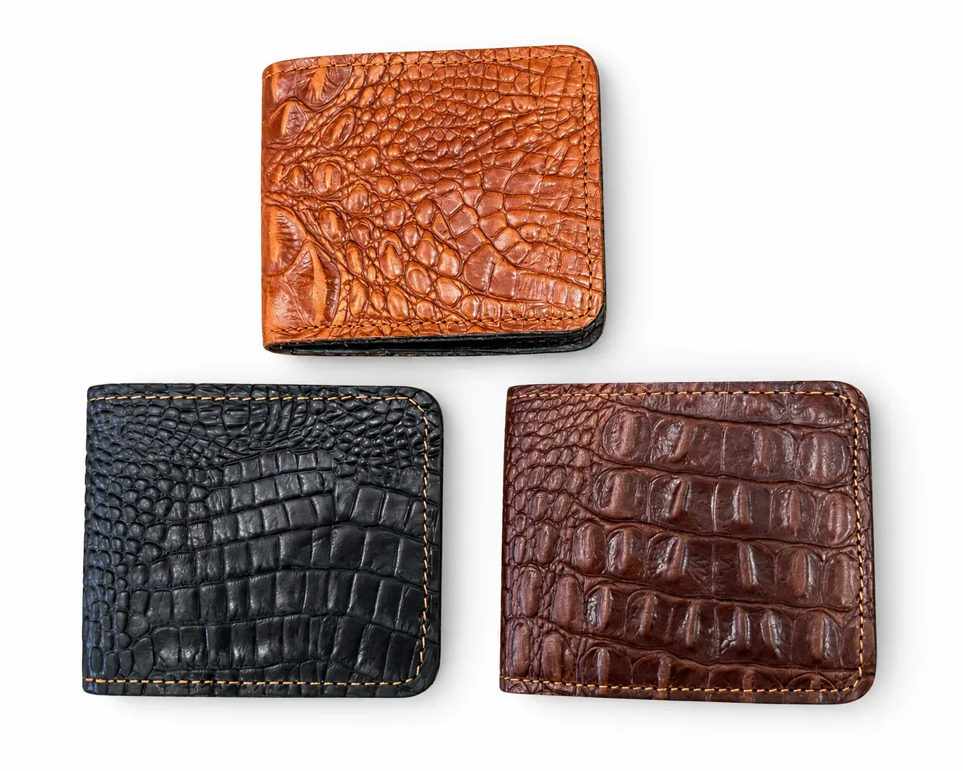 Three crocodile-pattern wallets in black, tan and dark brown arranged on a white background